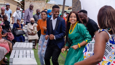 A joyful group of people celebrating at an outdoor event.