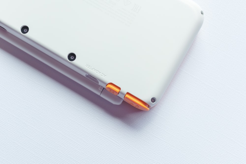 a close up of a white tablet on a white surface