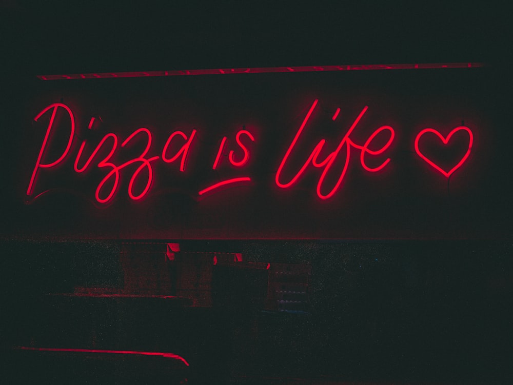 a neon sign that says pizza is life