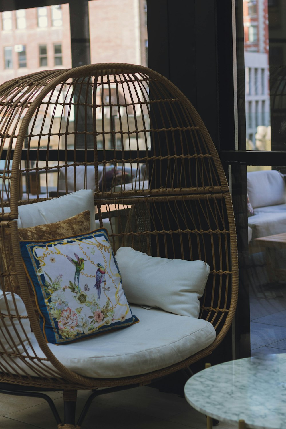 a rattan chair with a pillow on top of it