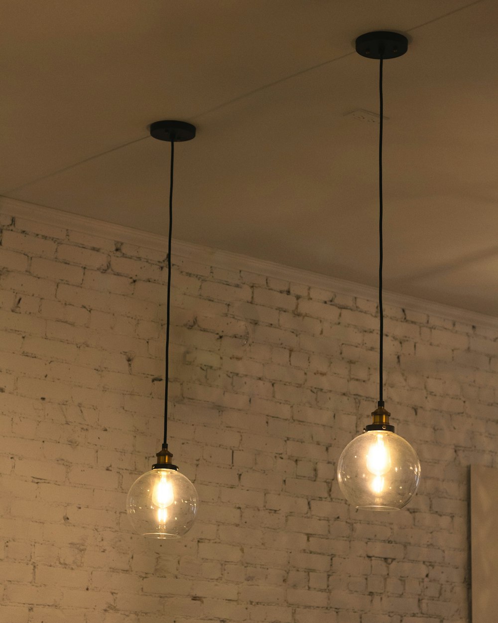 a couple of lights hanging from a ceiling