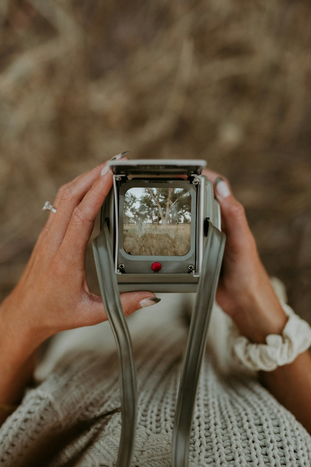 a woman holding a camera up to take a picture