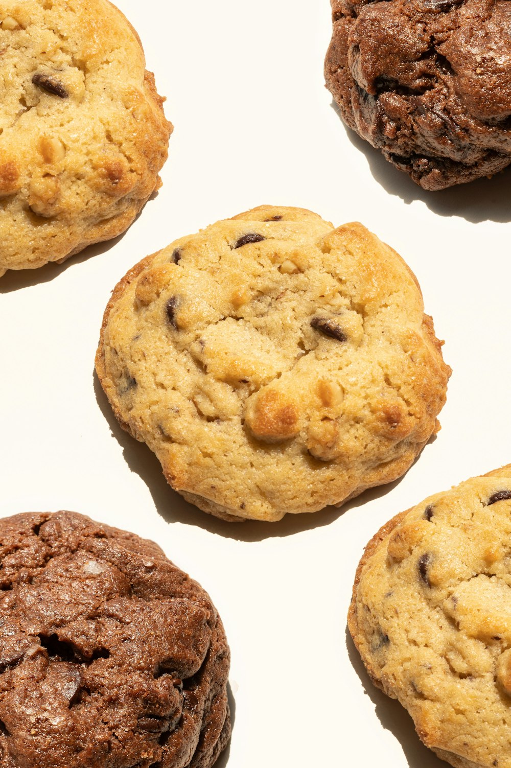 a close up of four chocolate chip cookies