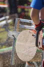 a man using a chainsaw to cut a tree