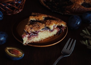 Dark moody food photography of a plum pie