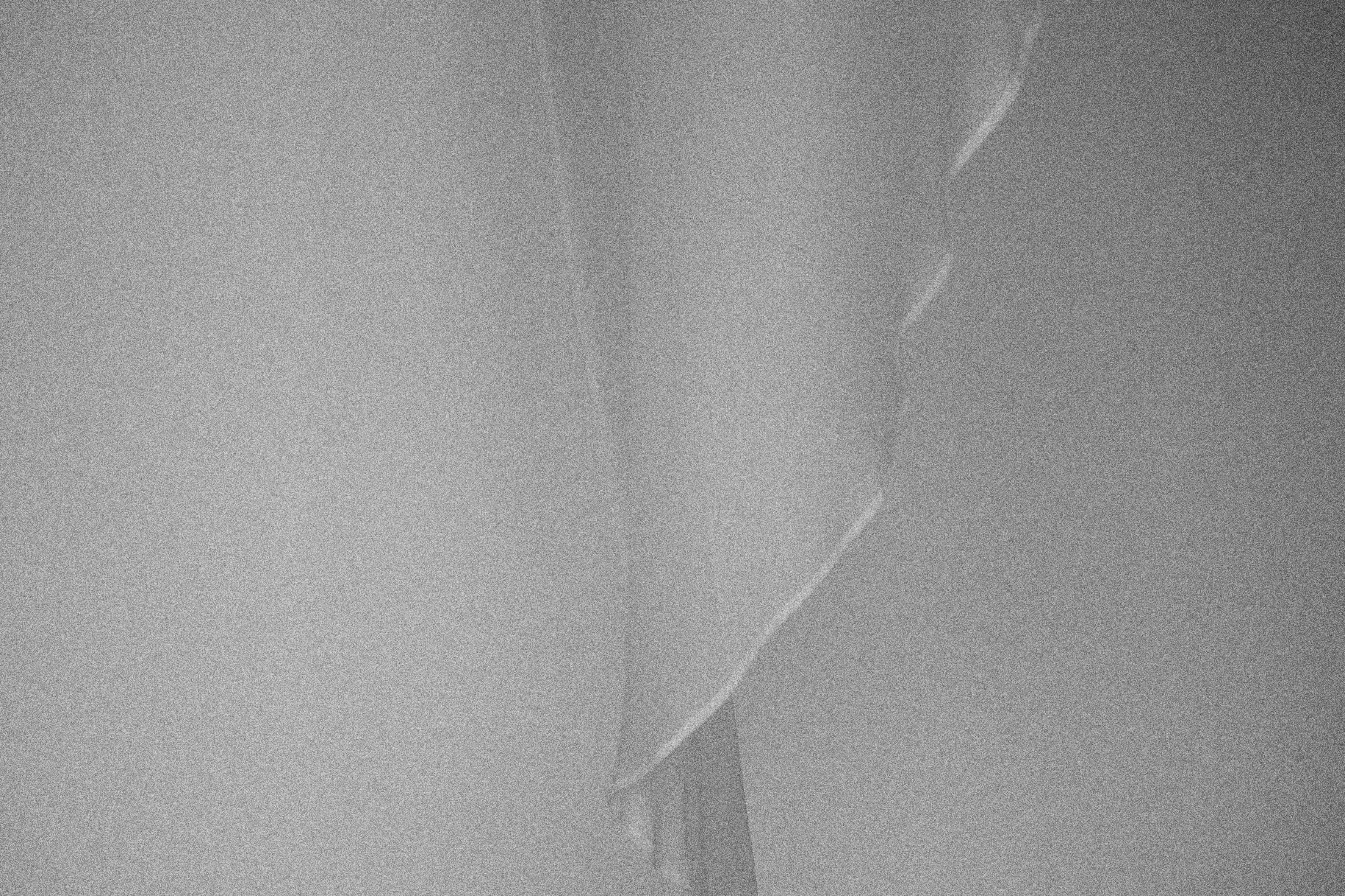 a black and white photo of a curtain