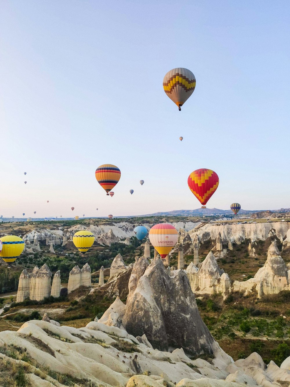 a bunch of hot air balloons flying in the sky