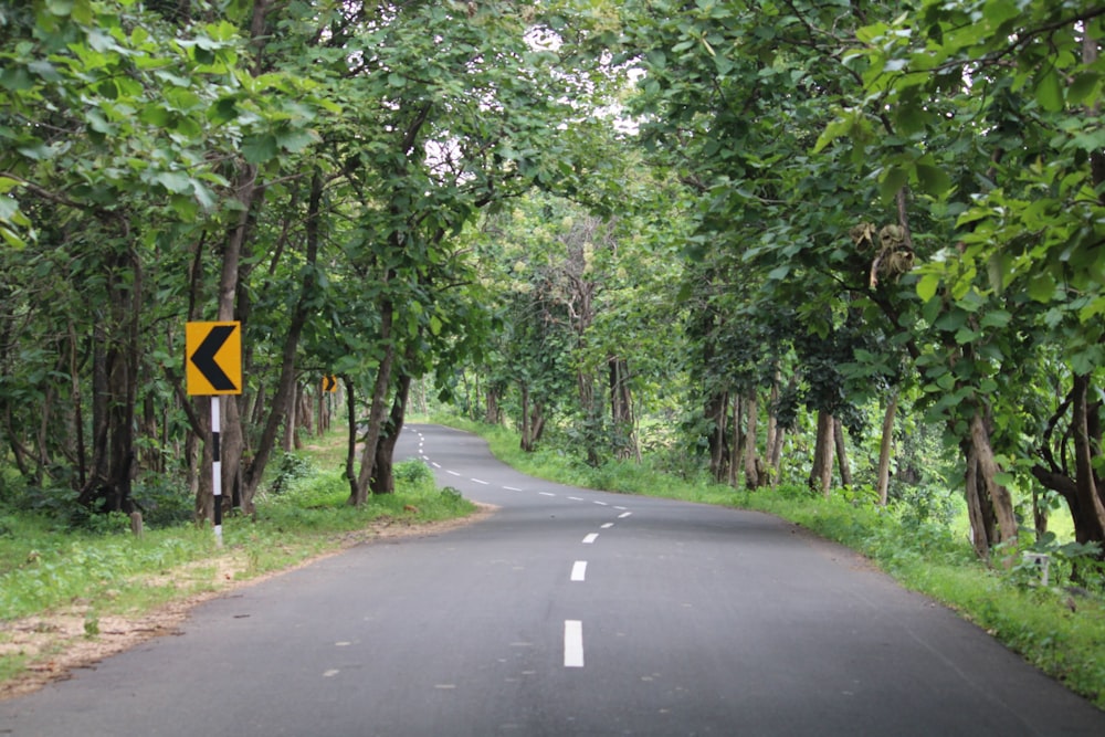 a road with a yellow sign on the side of it