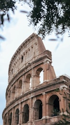a large stone building with a clock on it's side