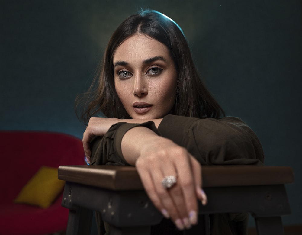 a woman sitting at a table with her hand on the table