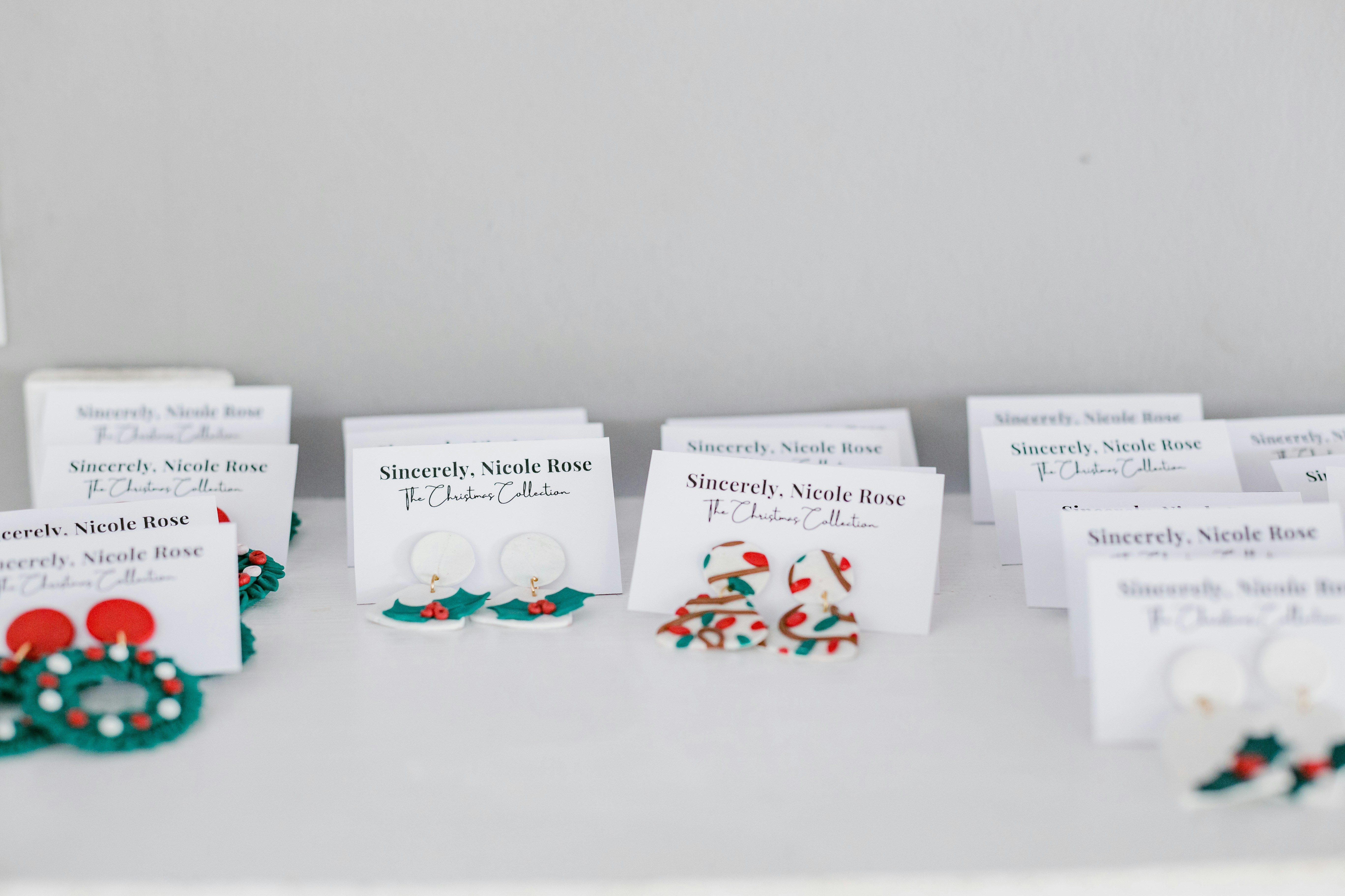 a table topped with lots of different types of earrings