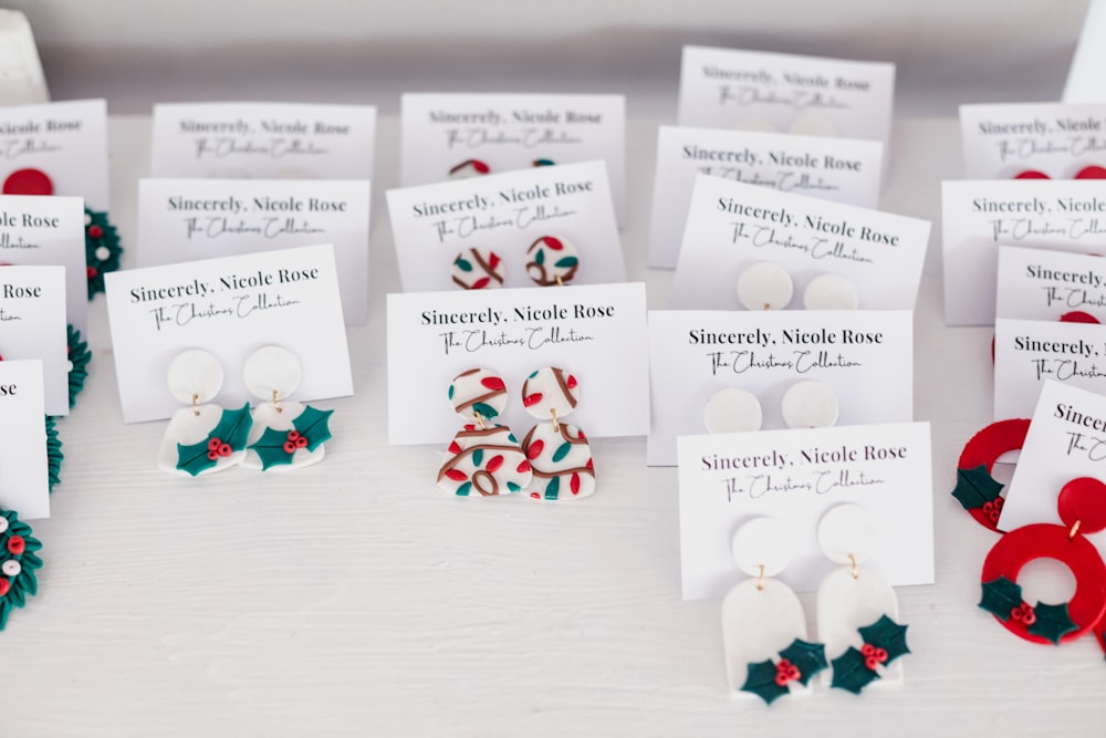 a table topped with lots of different types of earrings