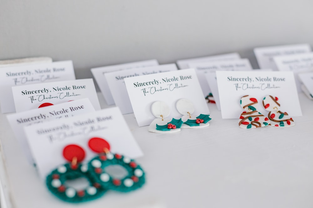 a table topped with lots of different types of earrings