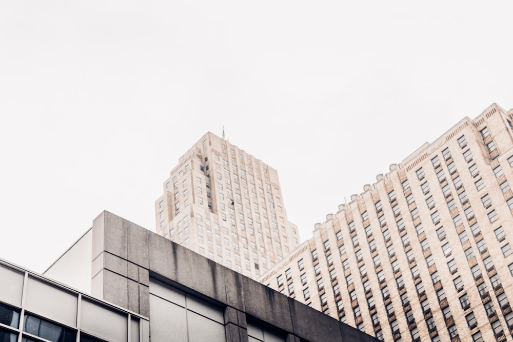 a couple of tall buildings sitting next to each other