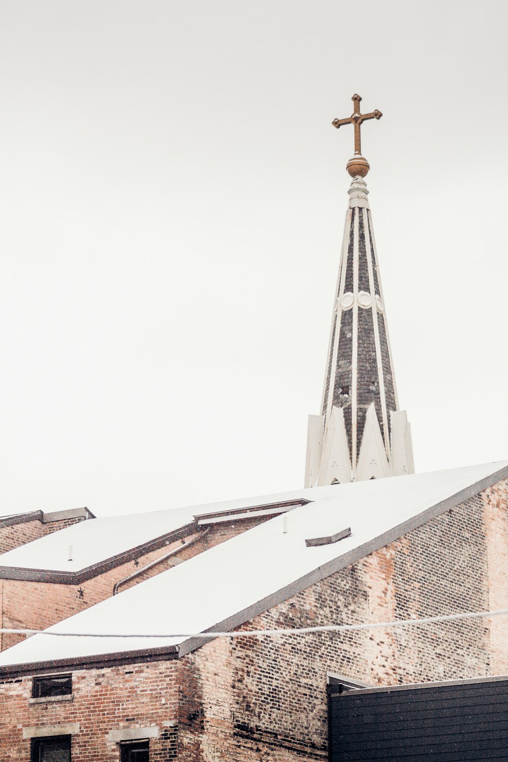 a church steeple with a cross on top of it