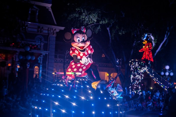 Bright and colorful nighttime parade at Universal Studios with lively characters and floats.