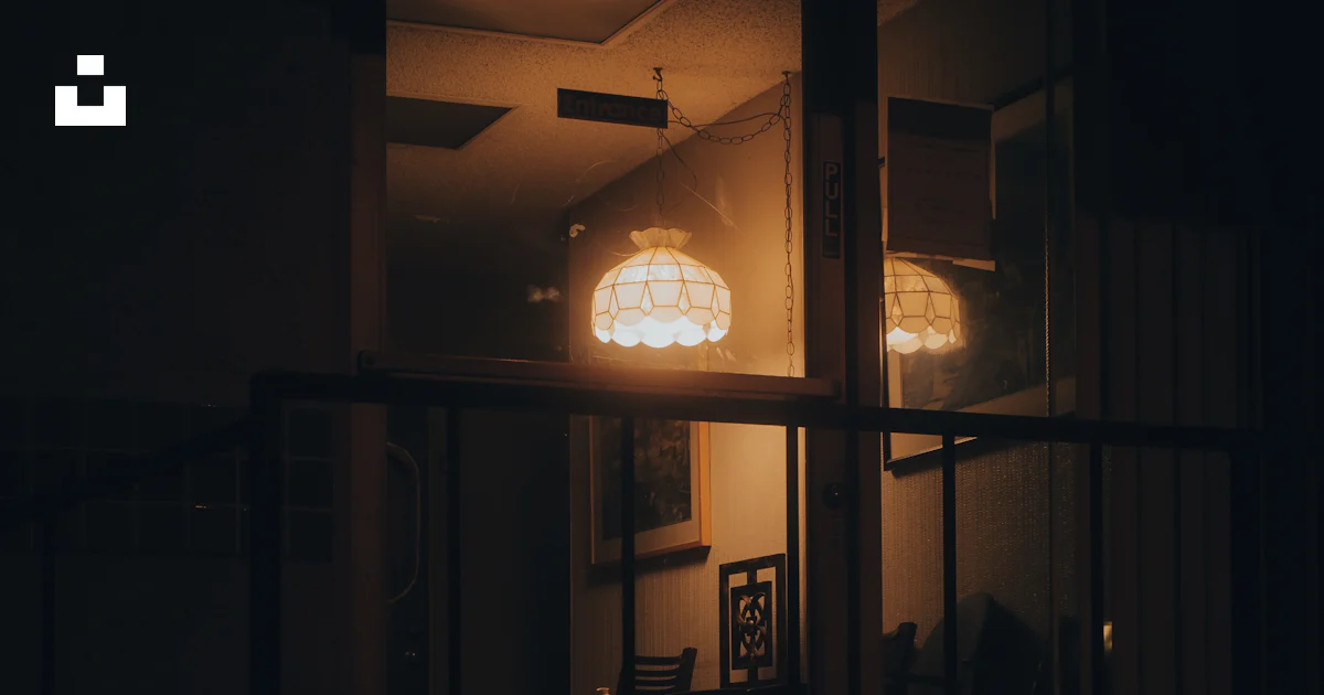 A dimly lit room with a table and chairs photo – Free Lighting Image on ...