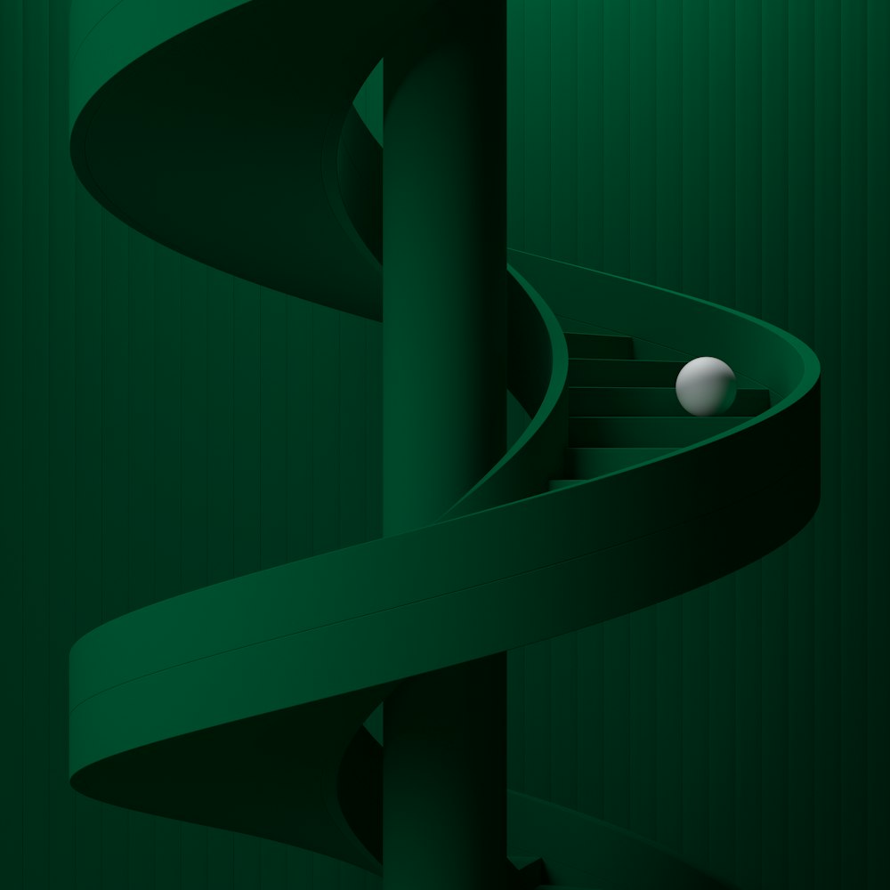 a green spiral staircase with a white ball in it