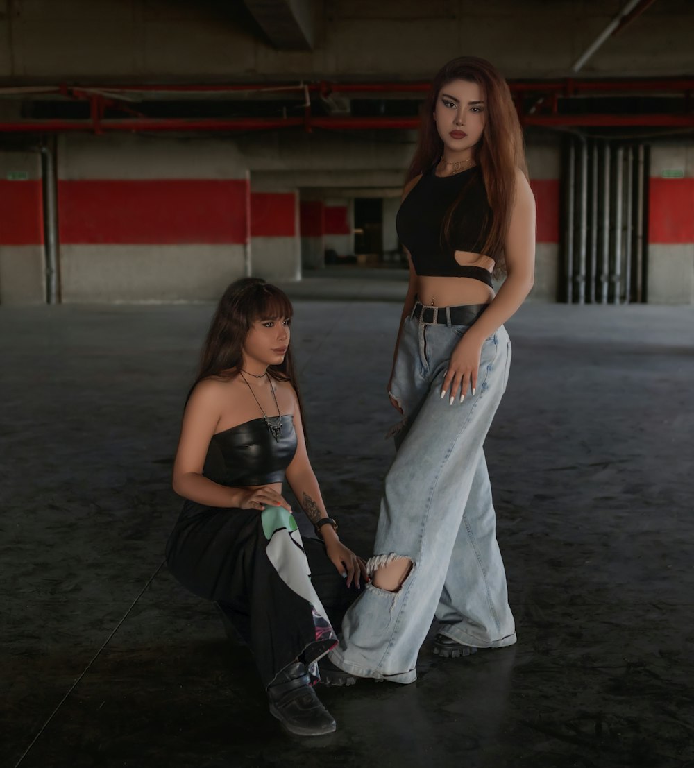two women standing next to each other in a garage