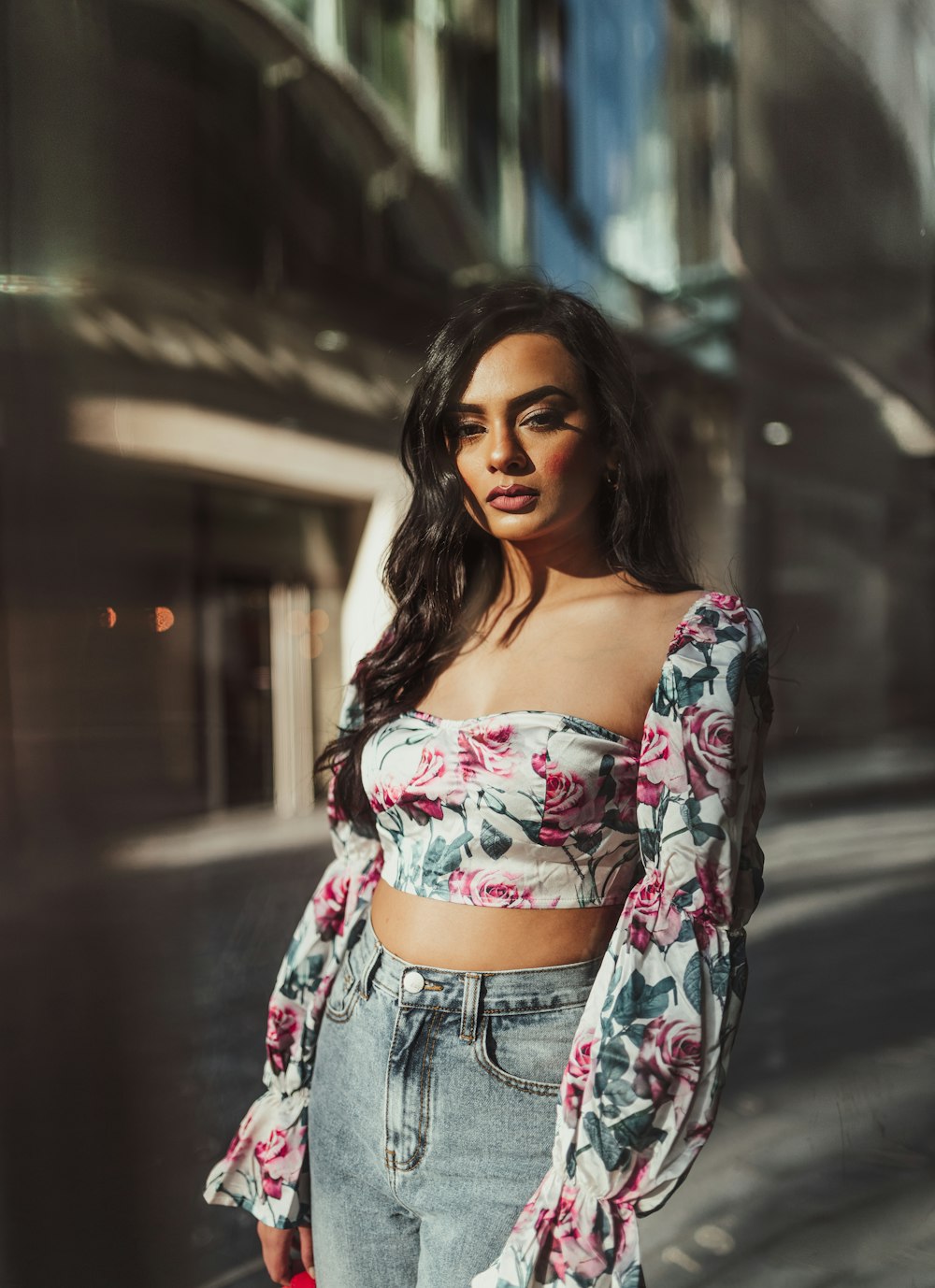 a woman standing on the street wearing a crop top