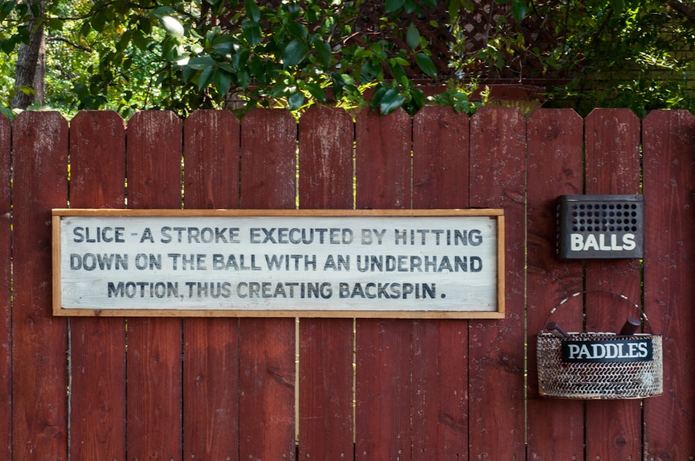 a wooden fence with a sign on it