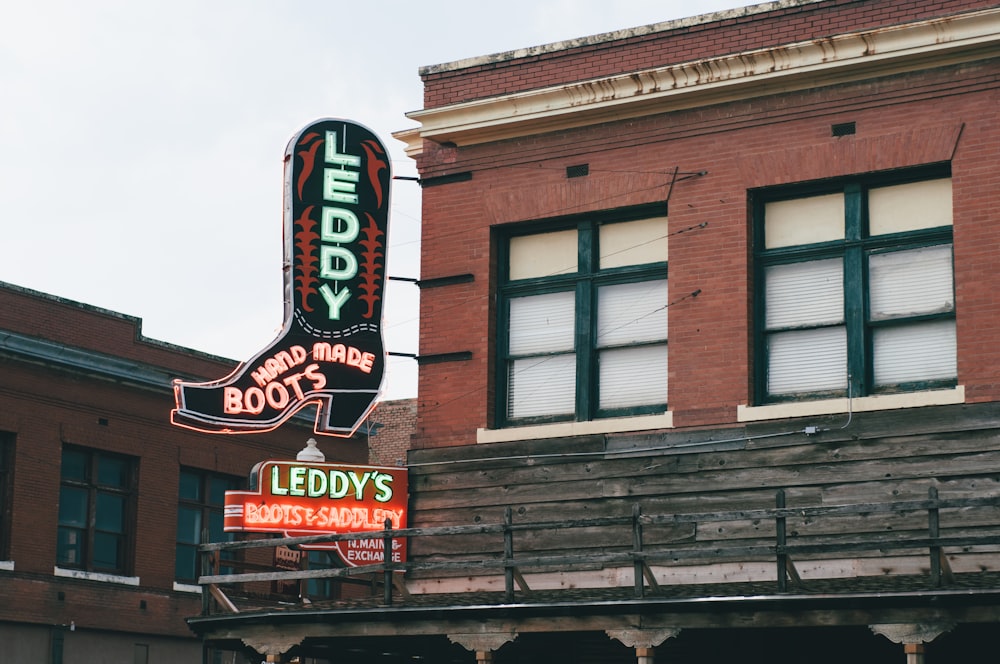 a building with a neon sign that says lucky boot