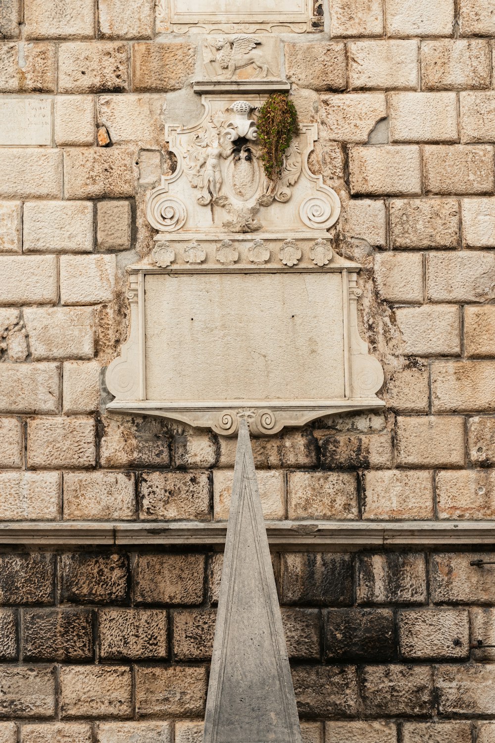a white clock mounted to the side of a brick building