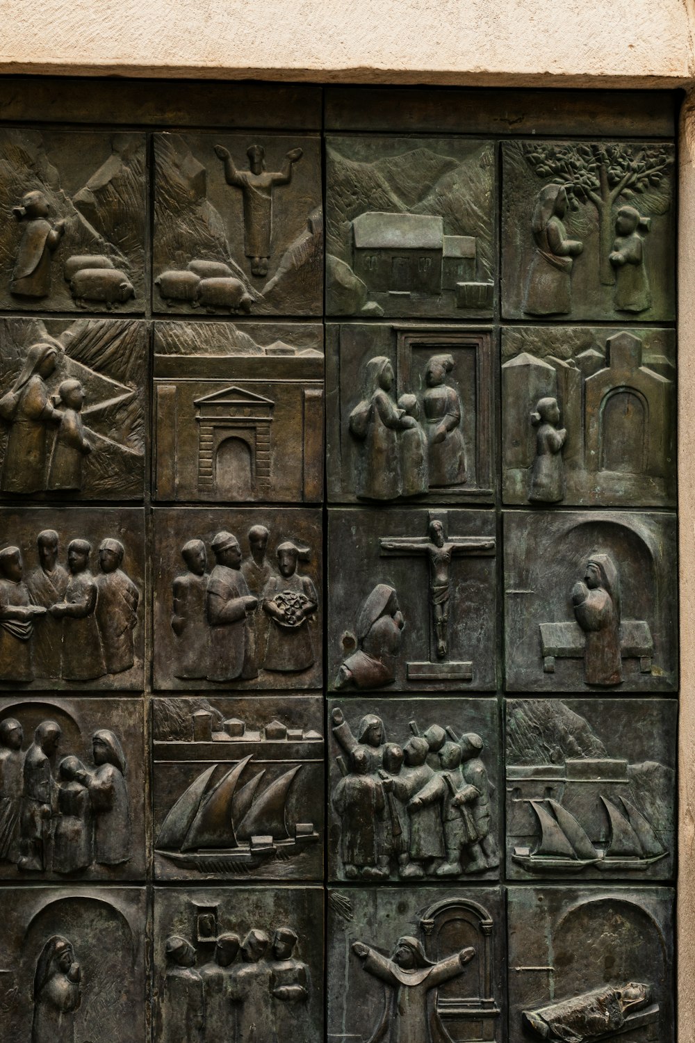 a close up of a metal door with a bunch of carvings on it