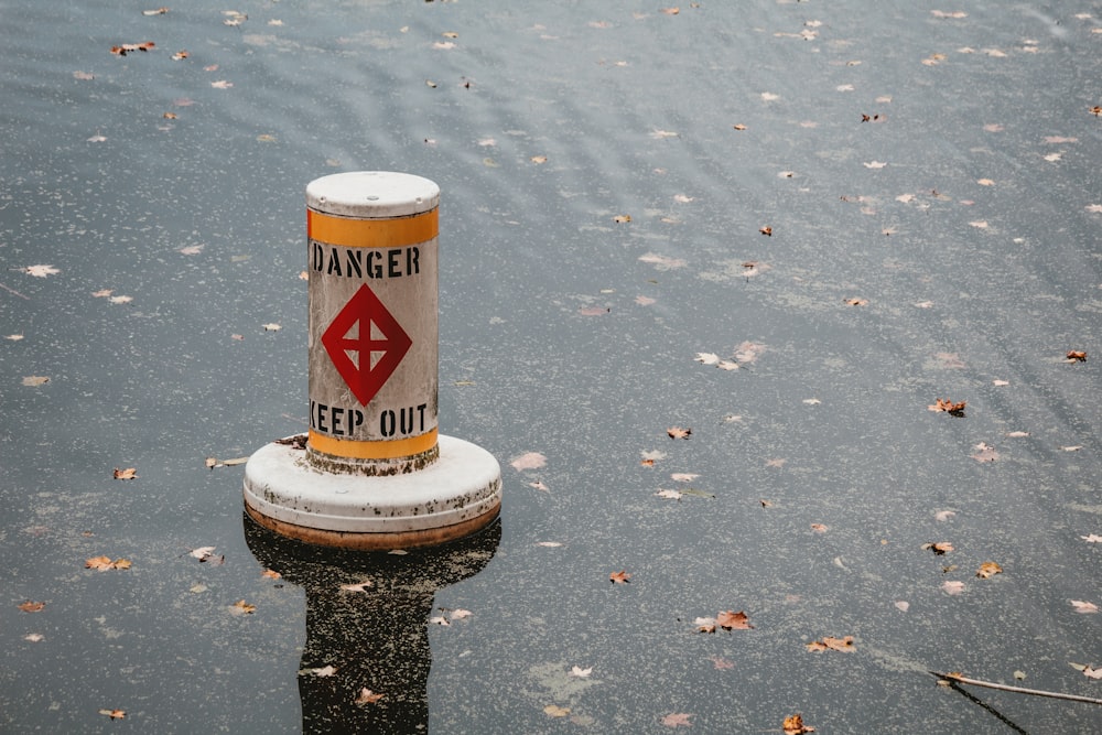 a sign that is on a pole in the water