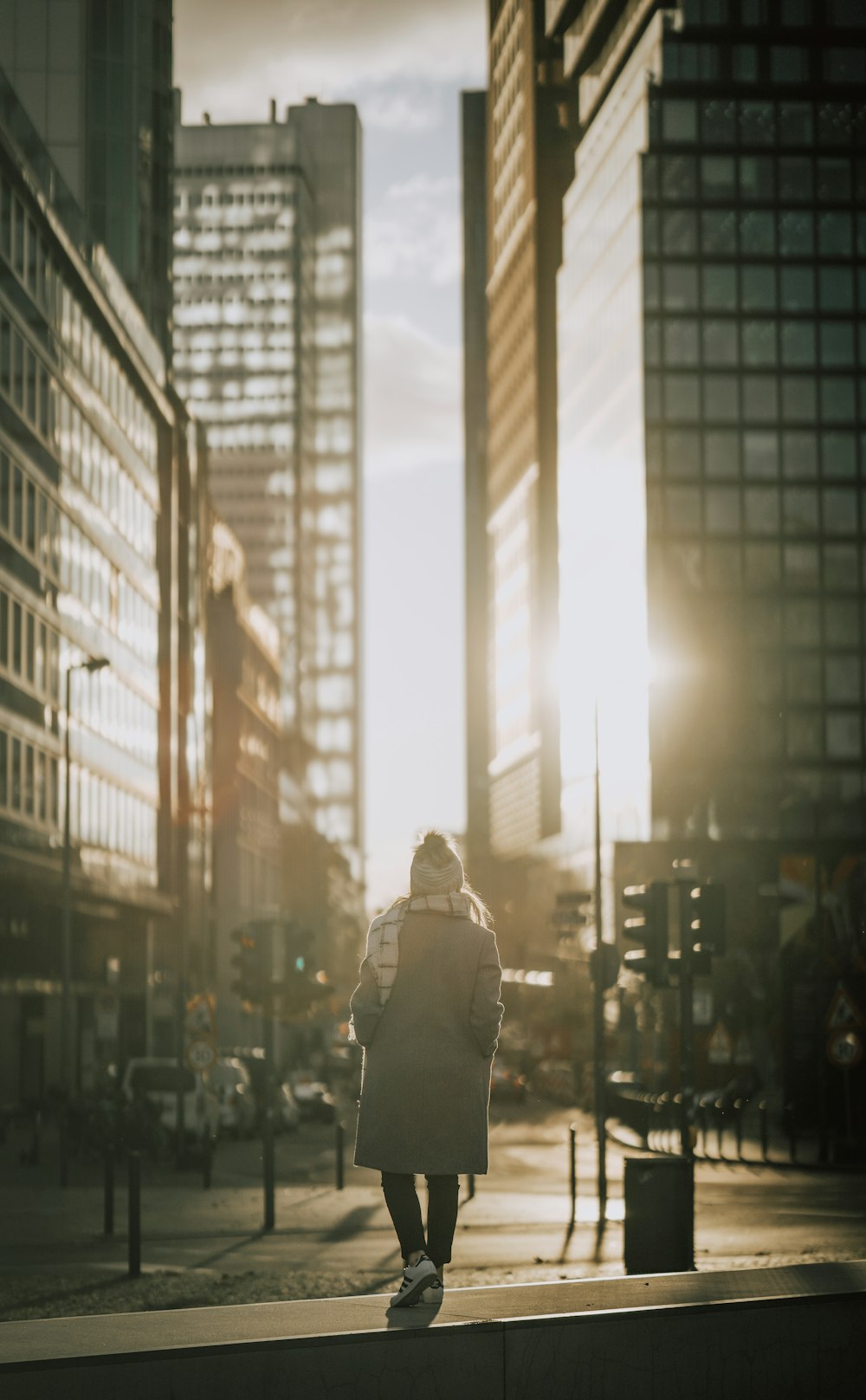 a person walking down a sidewalk in a city