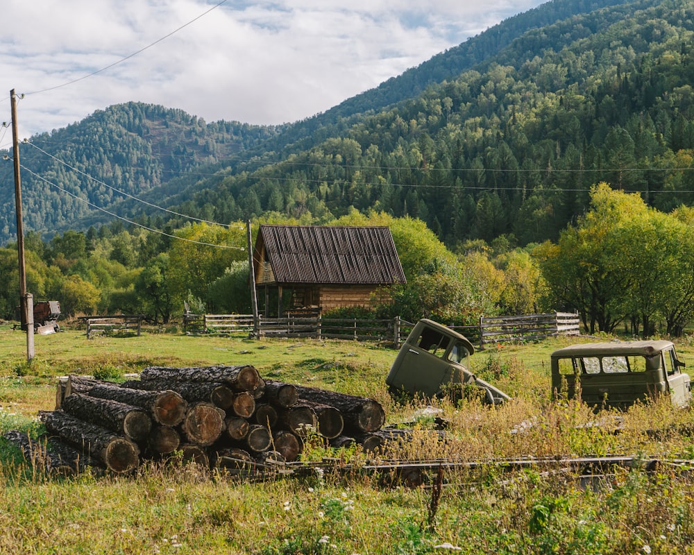 a couple of old cars sitting in a field