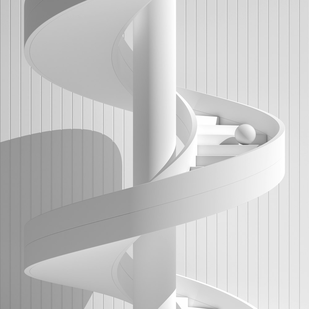 a white spiral staircase in a white room