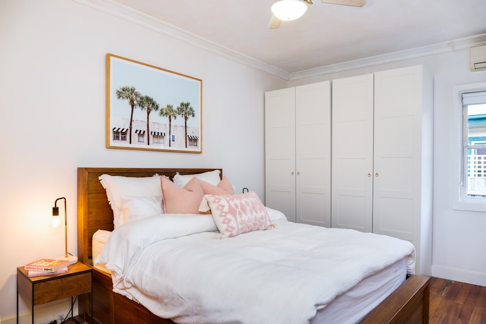 a bedroom with a bed, dresser, and window