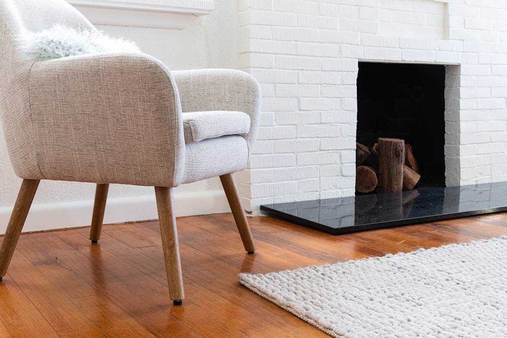 a chair sitting in front of a fireplace in a living room