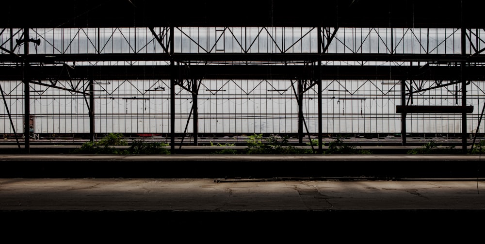 a train traveling down train tracks next to a tall building