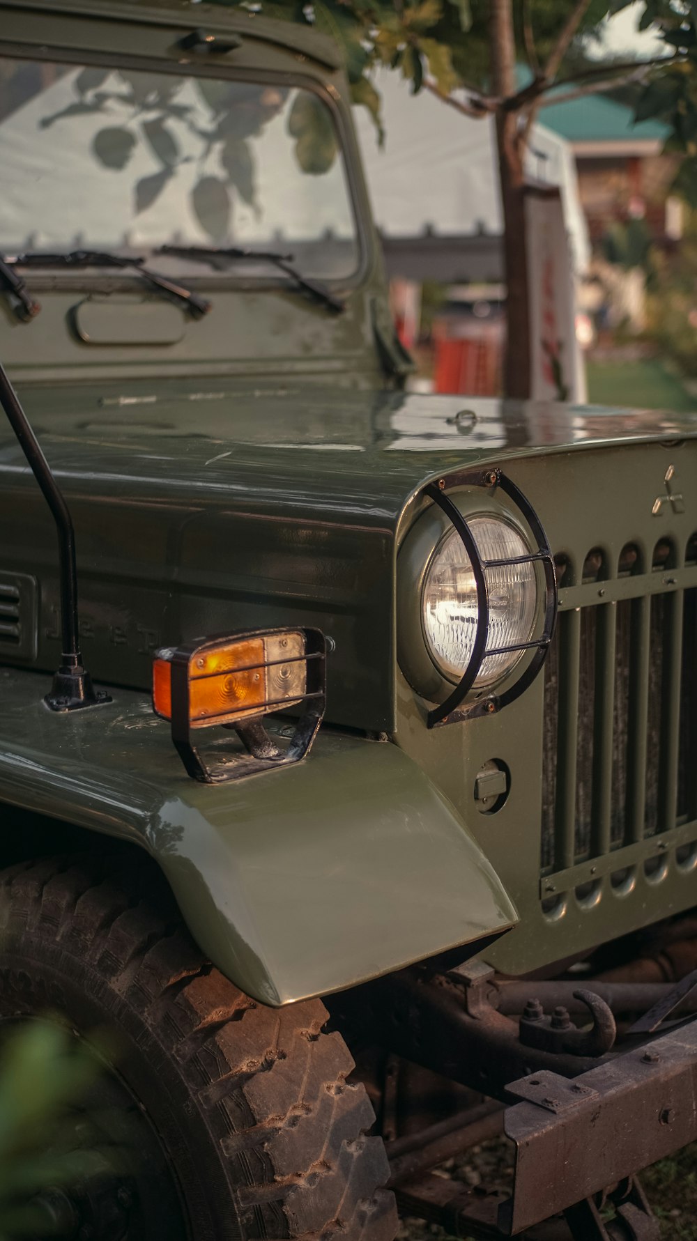 a green jeep is parked in the grass