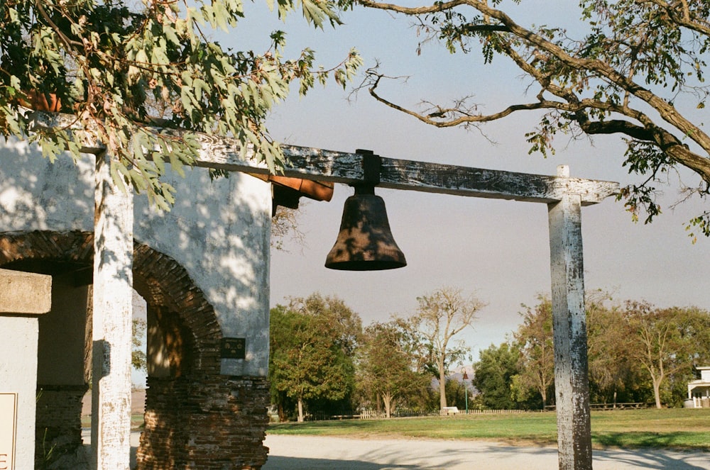 a bell is hanging from the side of a building