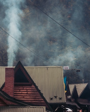 smoke billows from the roof of a house