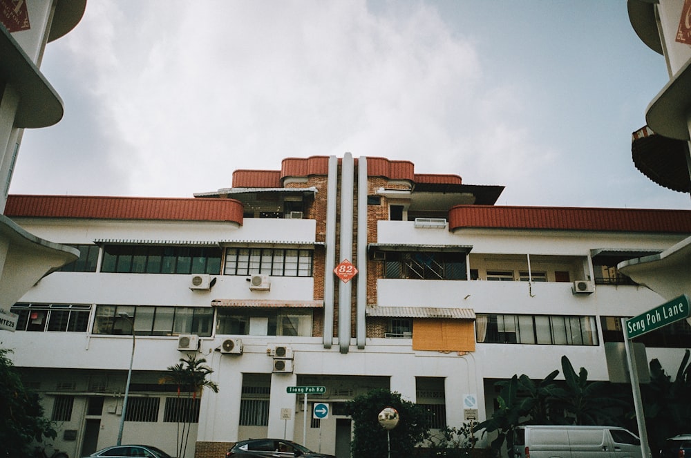 a tall white building with a red roof