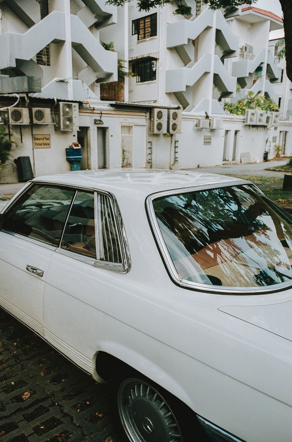 a white car parked in front of a building