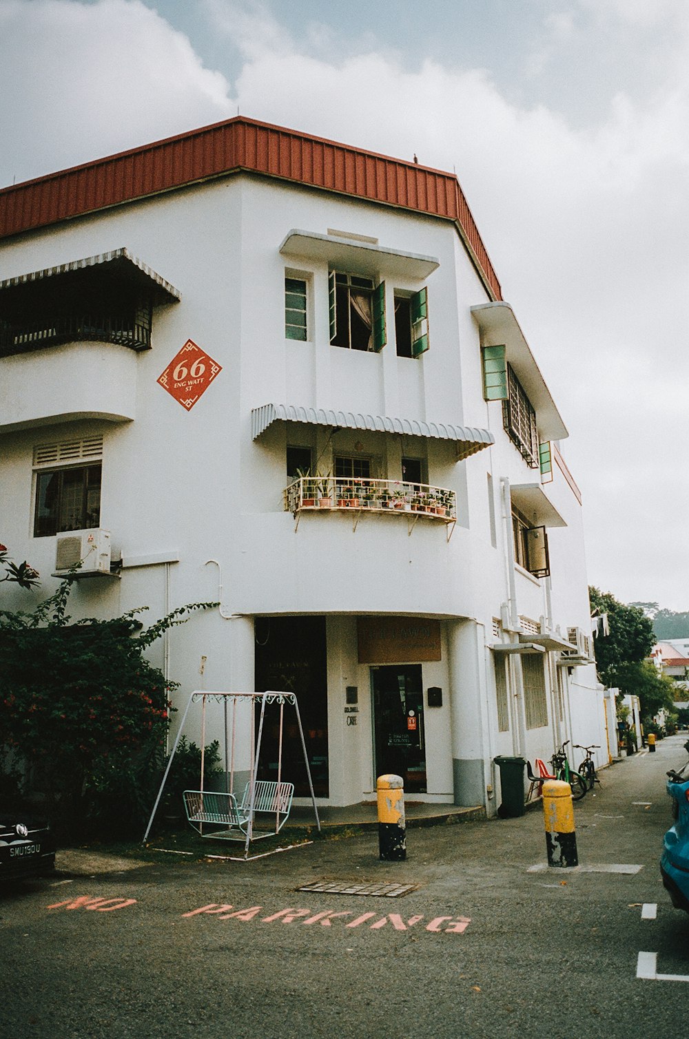 a white building with a red stop sign in front of it