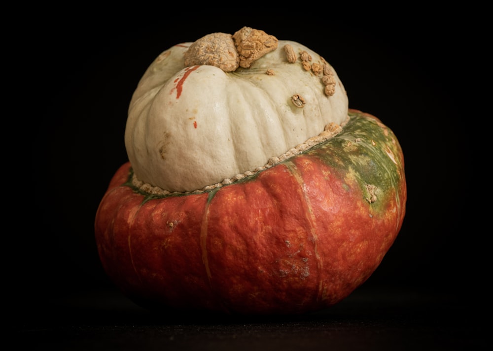 a large pumpkin with a couple of small pumpkins on top of it