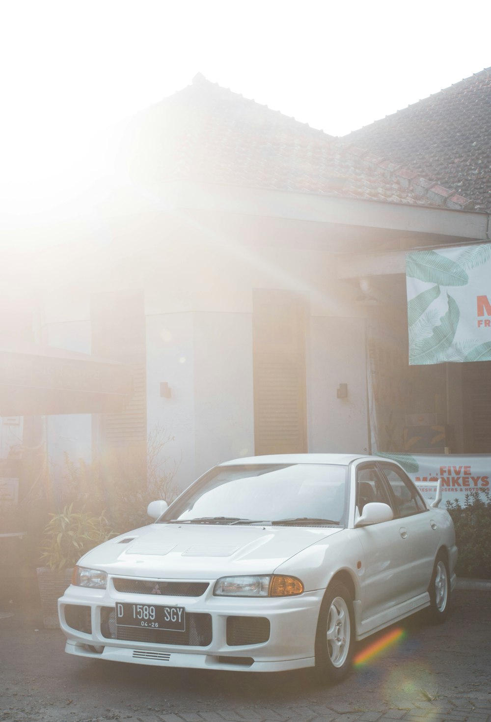 a white car parked in front of a building