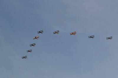 A group photo of aerohobby club members smiling proudly beside their latest flying creations.