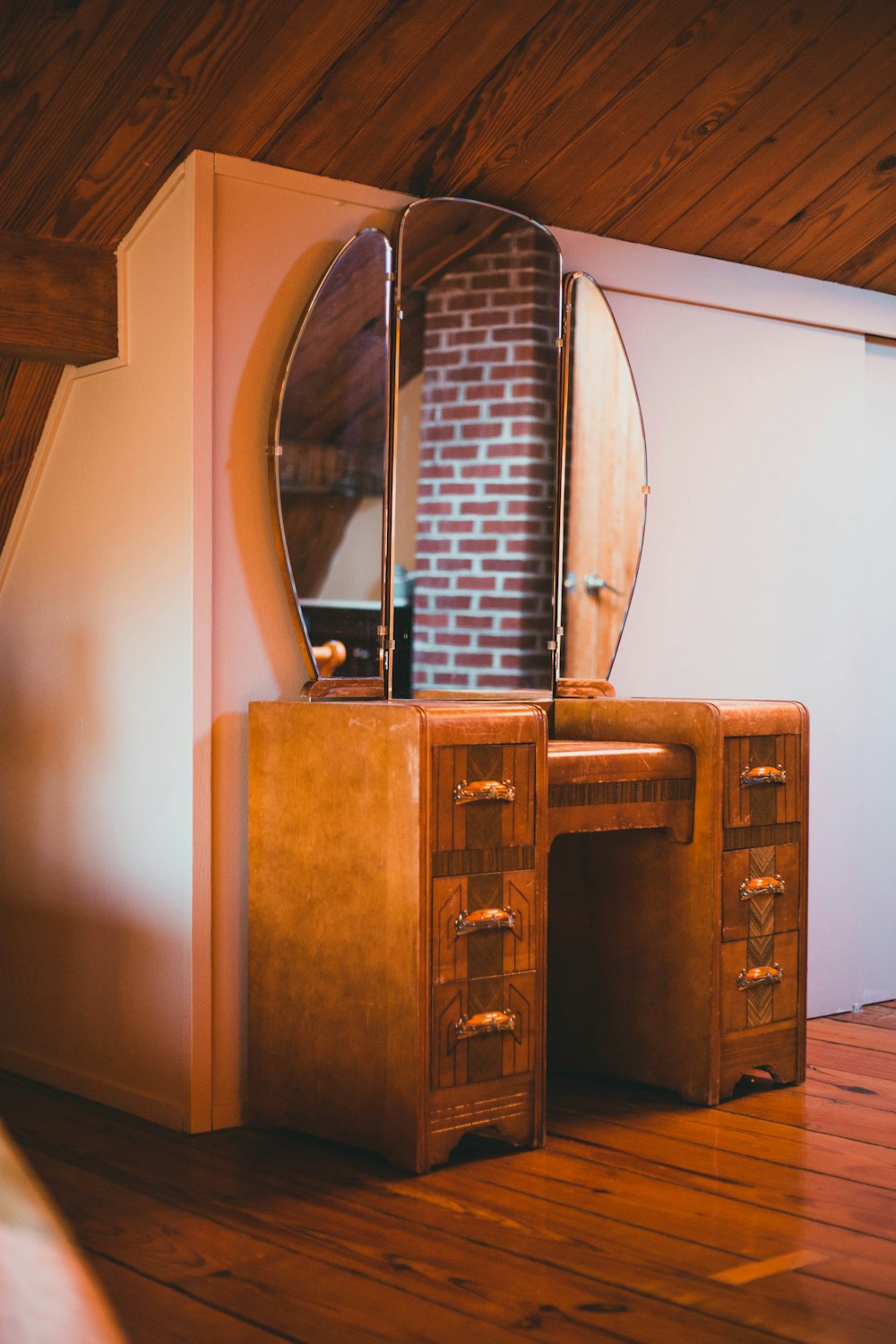 a wooden desk with a mirror on top of it