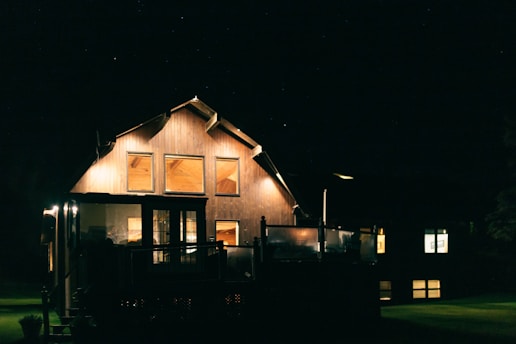 a house lit up at night with the lights on