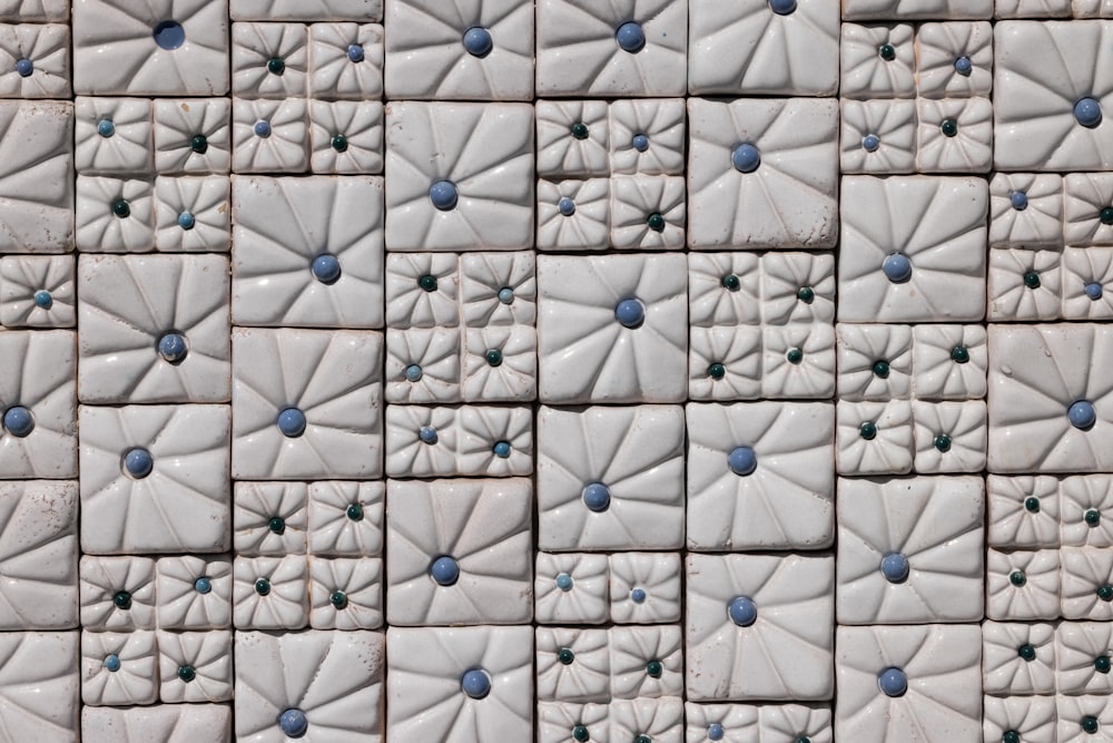 a close up of a white and blue tile wall