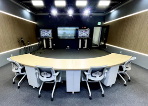 A sleek conference room setup with vibrant audiovisual equipment ready for a corporate presentation.