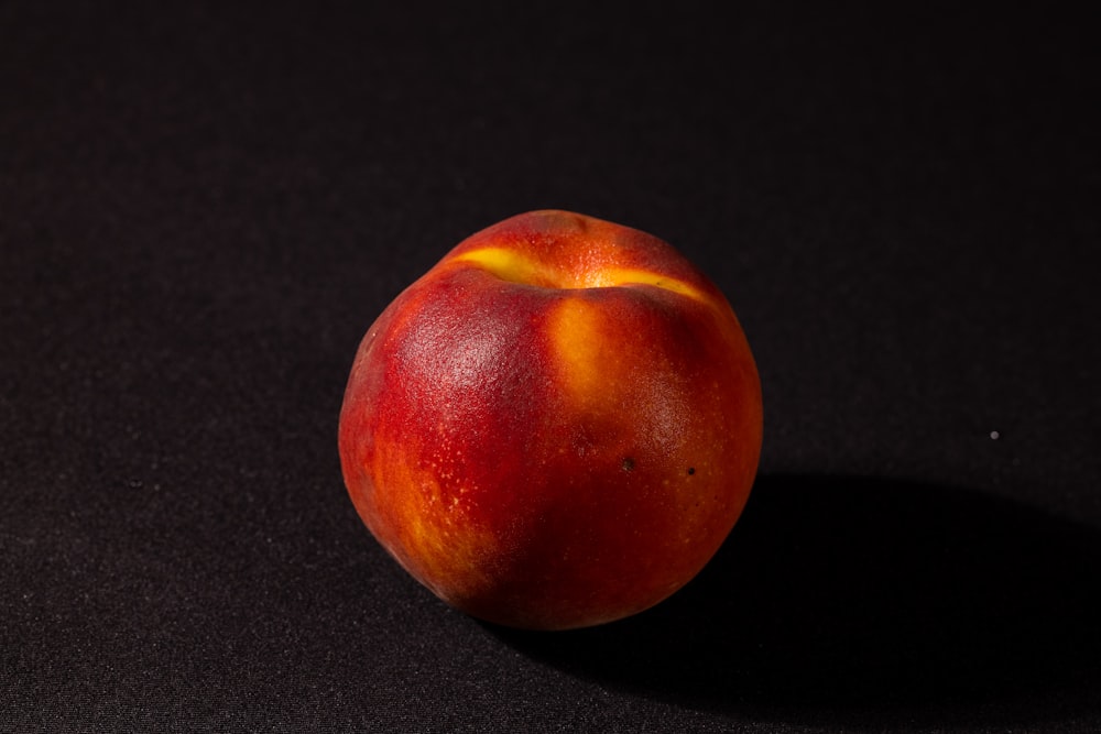 a close up of a peach on a black background