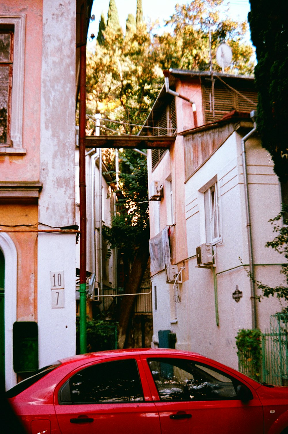 a red car parked on the side of a street